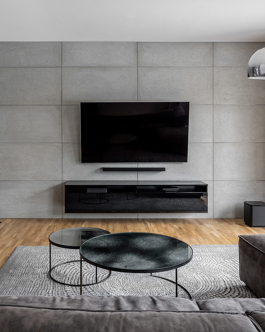 Tv living room with cement wall and wall mounted fireplace